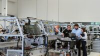people working over computer in factory